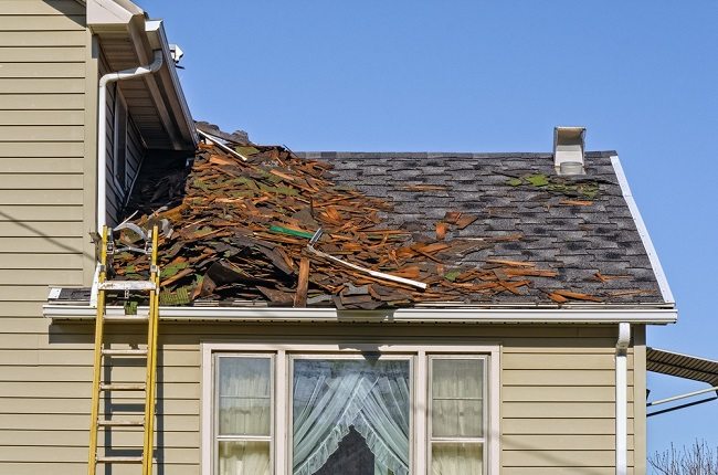Roof with debris and dislocated grey tiles